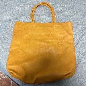 Brown leather tote bag with braided straps